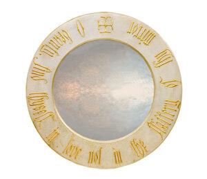 Large round silver decorative mirror with Gothic script lettering.